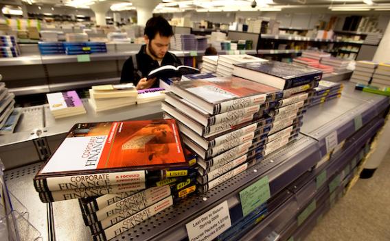 UMN student reads a book in the campus bookstore.