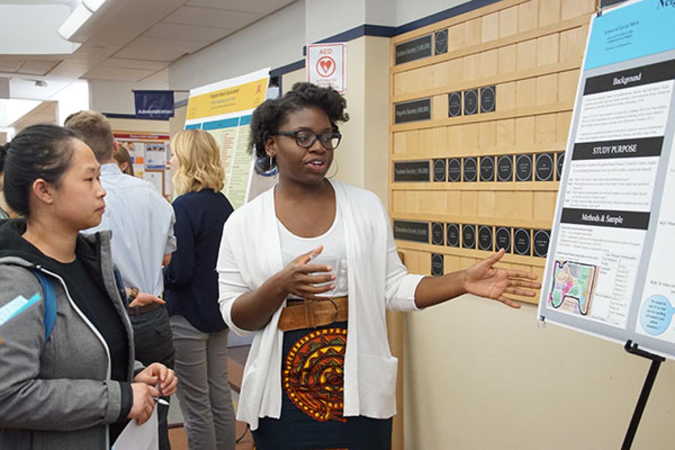 MSW student discussing research with a fellow student.