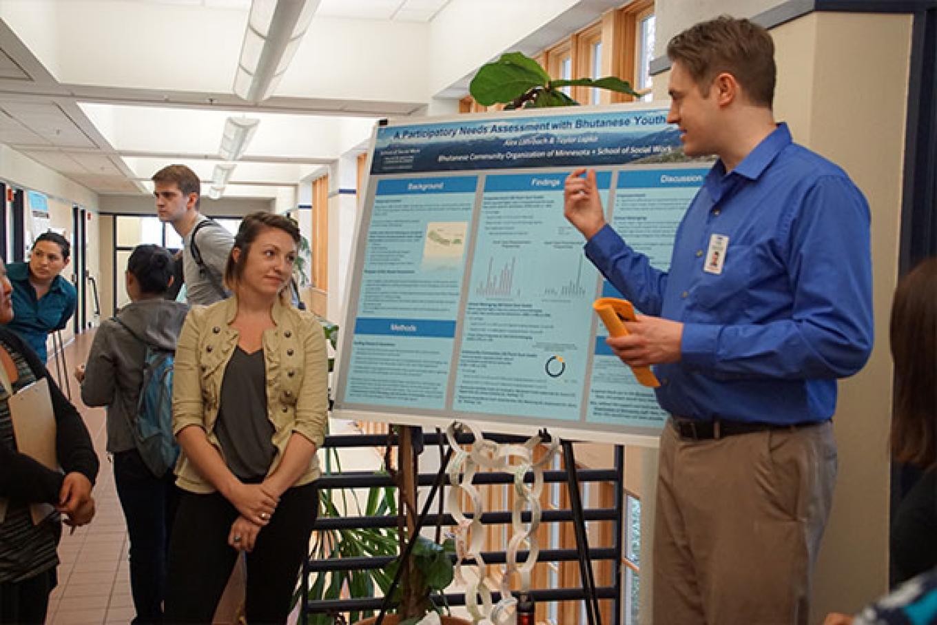 MSW students Alex and Taylor explained their project for advanced social work evaluation.