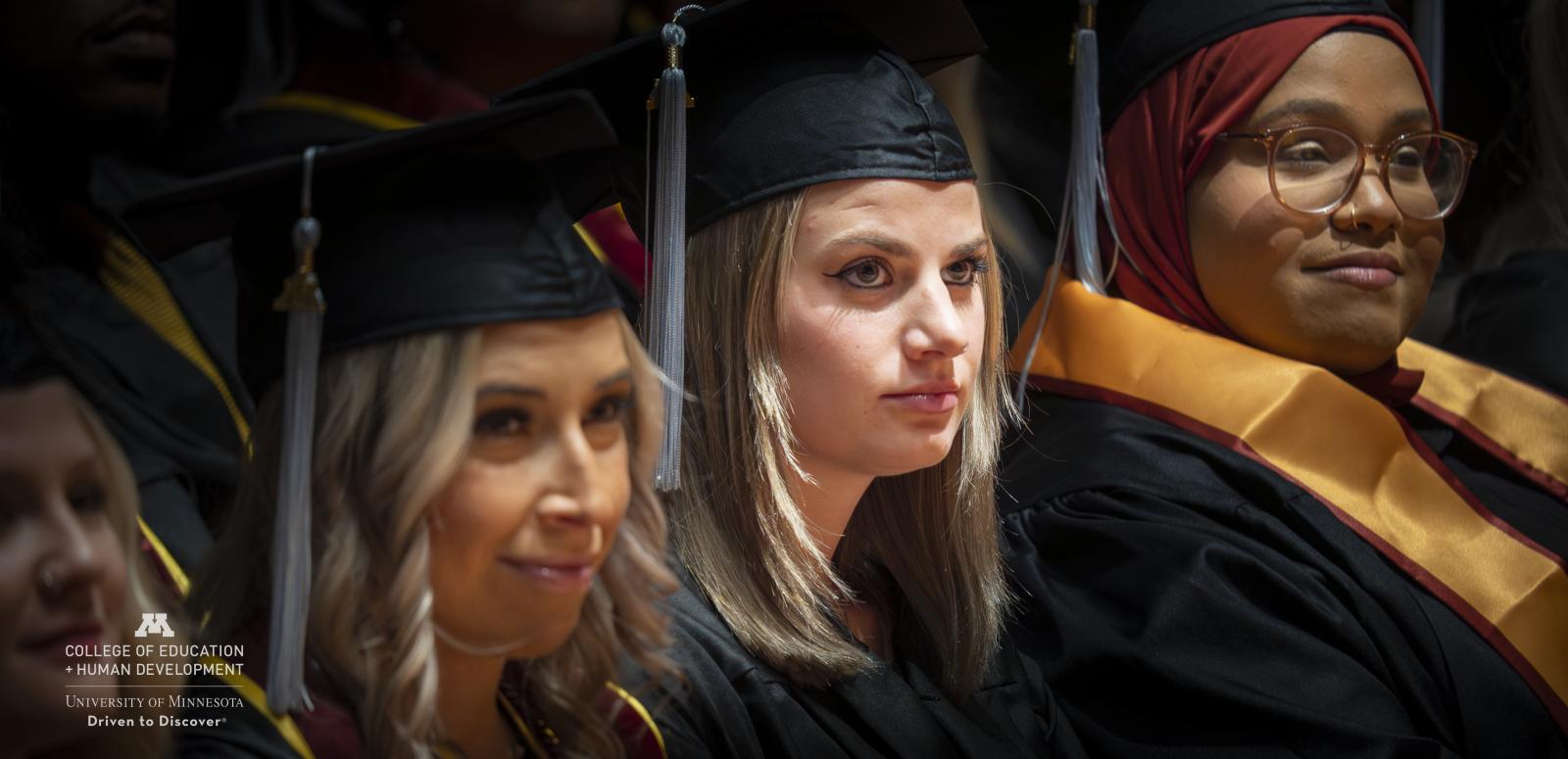 Graduation ceremony 2023. Students in caps and gowns, sitting.